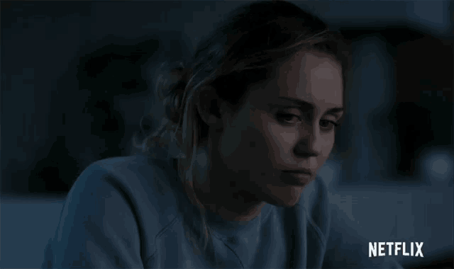 a close up of a woman 's face with the word netflix on the bottom right