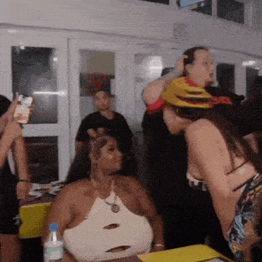 a group of people are gathered in a room with one wearing a helmet that says sb