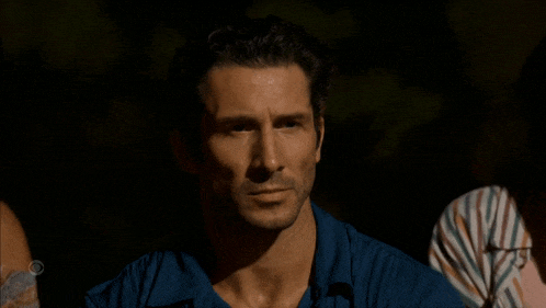 a man in a blue shirt has a cbs logo on his shoulder