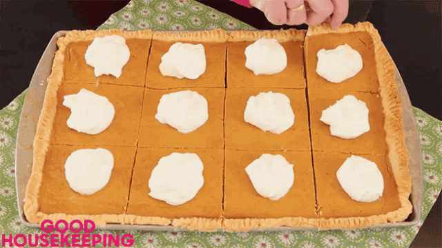 a pie with whipped cream on it is on a tray that says good housekeeping on it