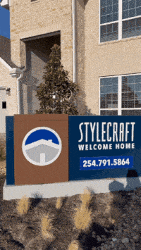 a stylecraft welcome home sign is in front of a house