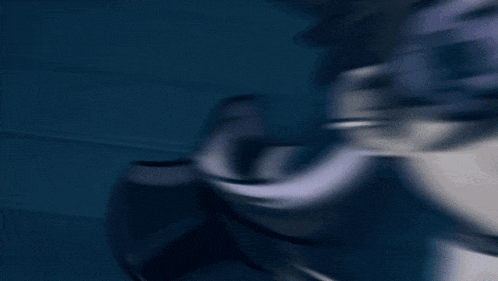a blurry picture of a person 's face in a dark room with a blue background