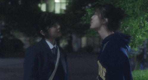 two girls are standing next to each other and one has a sweatshirt that says ' ucsd ' on it