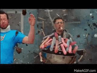 two men are standing in front of a bowl full of condoms