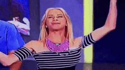 a woman in a striped top is dancing with her arms outstretched .