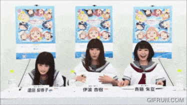 three girls are sitting at a table with a sign that says " gifrun.com " on it