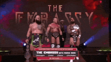 a group of wrestlers standing in front of a sign that says the embassy with prince nana
