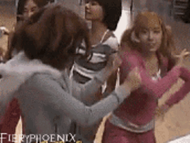 a group of girls are dancing in a room with fieryphoenix written on the bottom