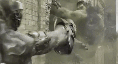the hulk is fighting a robot in a smokey room .