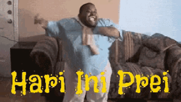 a man is dancing in front of a couch with the words hari ini prei written in yellow