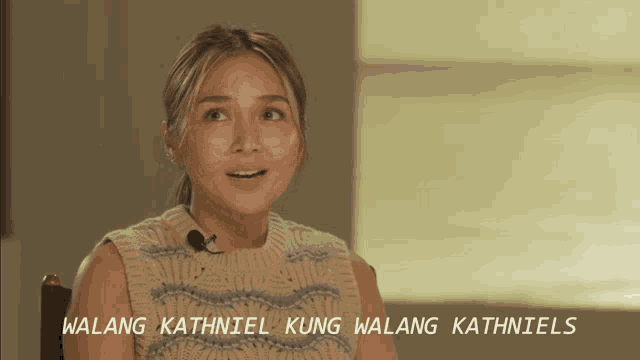 a woman wearing a sweater with the words " walang kathniel kung walang kathniels " on the bottom