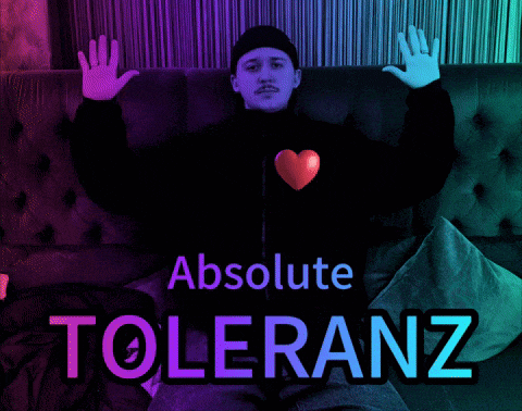 a man is sitting on a couch with his arms outstretched and the words " absolute toleranz " above him