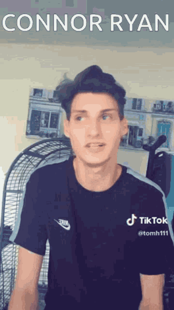 a man in a black t-shirt with the name connor ryan on it
