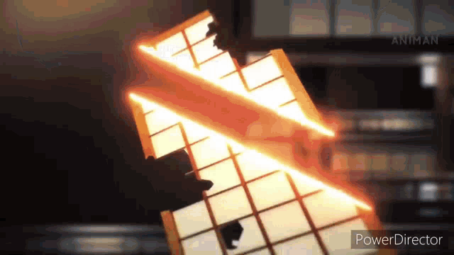 a person is standing in front of a building with a fire coming out of it