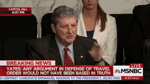 a man in a suit and tie is being interviewed on a breaking news channel