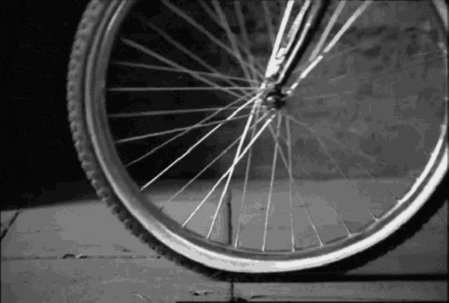 a close up of a bicycle wheel with a broken tire