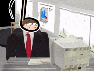 a man in a suit and tie sitting in front of a computer monitor