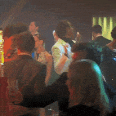 a woman in a sequined dress is dancing in a crowd