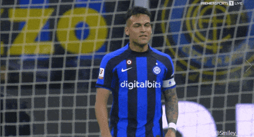 a soccer player wearing a blue and black jersey with the word digitalbits on it