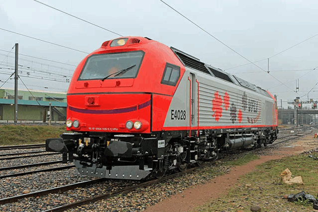 a red and white train with e4028 on the side of it