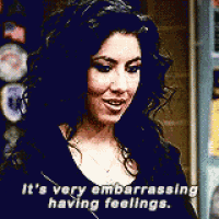 a woman is smiling and saying it 's very embarrassing having feelings .