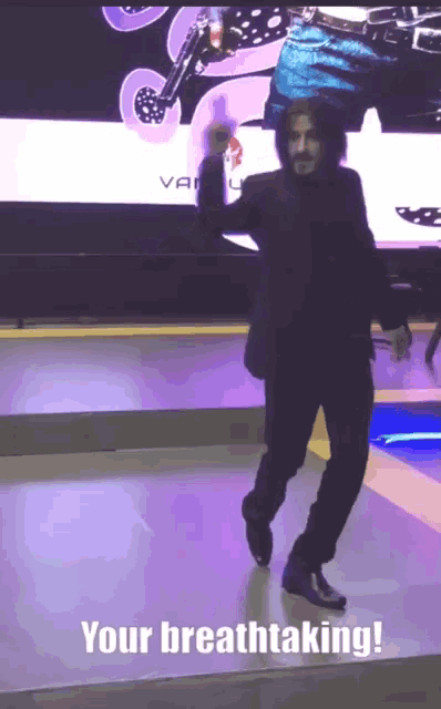 a man in a suit is dancing with the words your breathtaking written below him