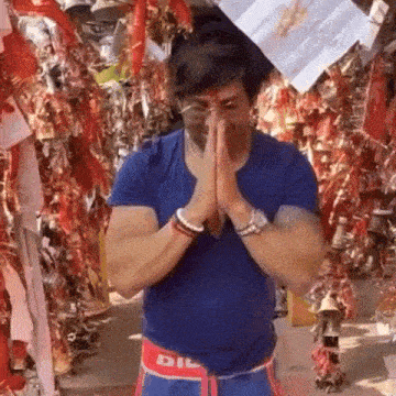 a man wearing a blue shirt with the word dil on the waist