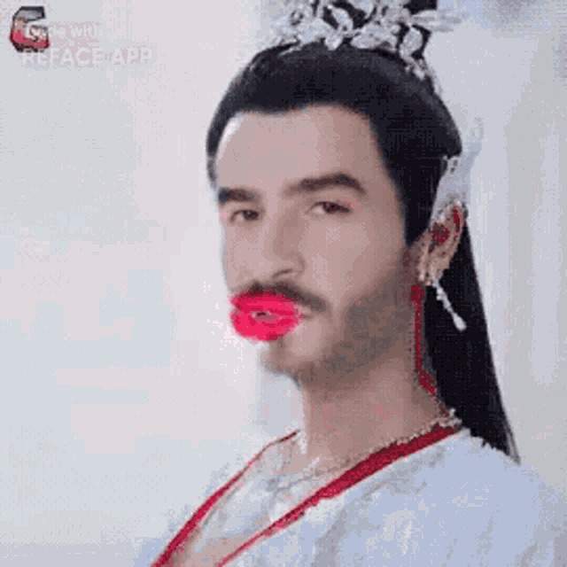a man with a beard and red lips is wearing a white dress and crown .