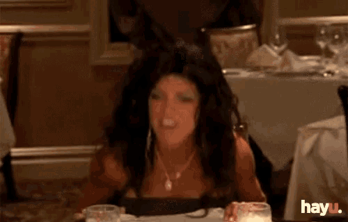 a woman is sitting at a table in a restaurant with hayu written on the bottom