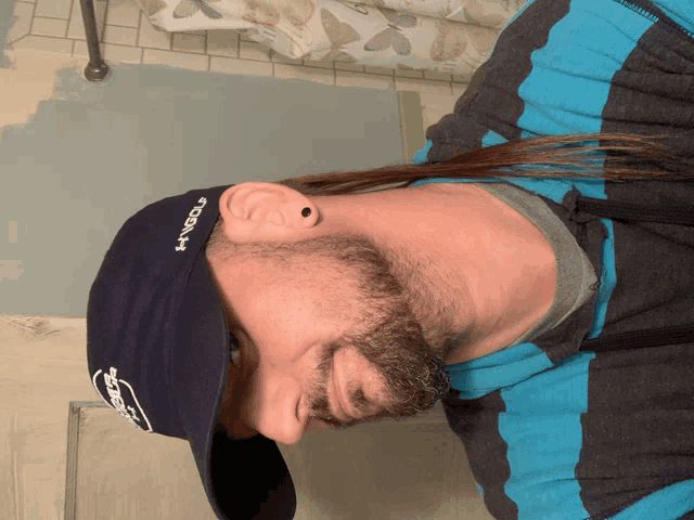 a man wearing a hat that says " under armour " on it