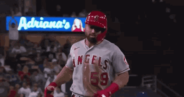 a couple of baseball players are standing next to each other on a baseball field .