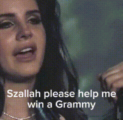 a woman is singing a song and asking for help to win a grammy