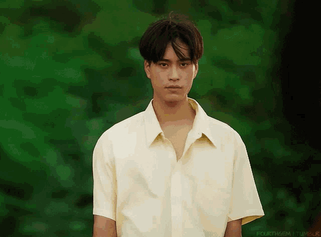 a young man in a yellow shirt is standing in front of a green background that says fourthgem tumblr