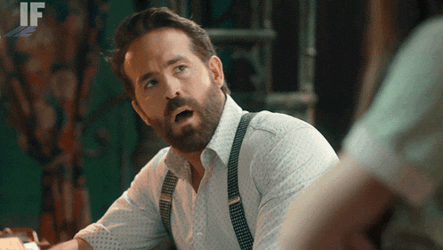 a man with a beard wearing suspenders and a white shirt with the word if on it