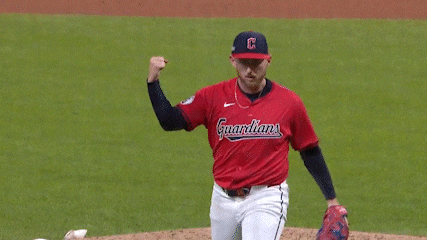 a baseball player wearing a red guardians jersey