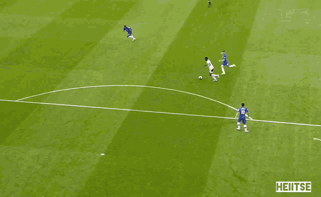 a soccer game is being played on a field that has the word hentee on it