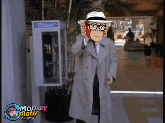 a man in a trench coat standing in front of a phone booth