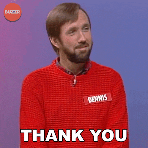 a man wearing a red sweater with a name tag that says dennis