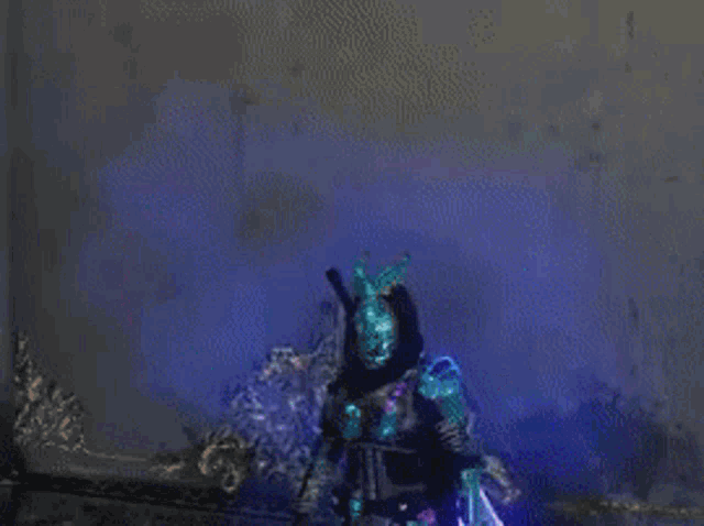 a statue of a demon with horns is standing in front of a purple and blue background .