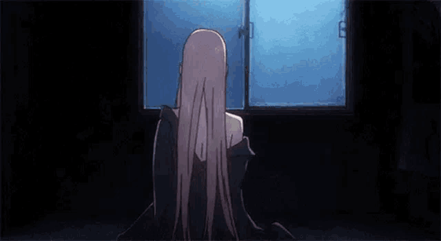 a girl with long hair is standing in front of a door .