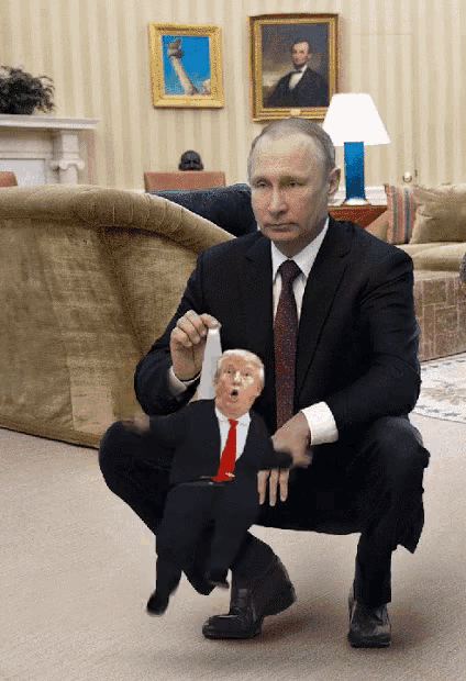 a man in a suit and tie is squatting down with a donald trump puppet