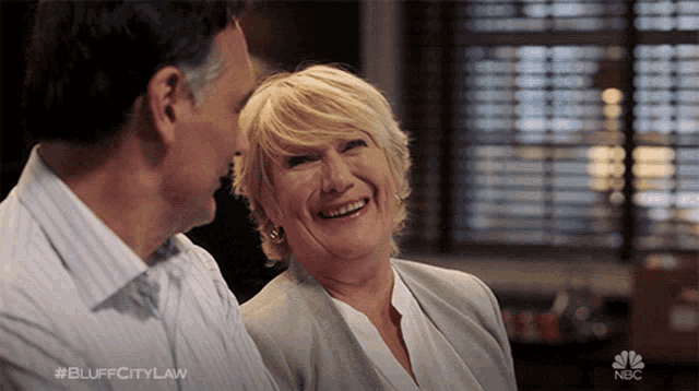 a man and a woman are laughing in a scene from nbc 's bluff city law