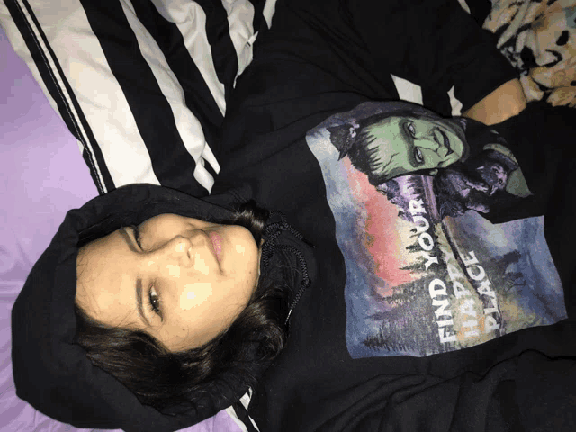 a woman wearing a hoodie that says find your black place