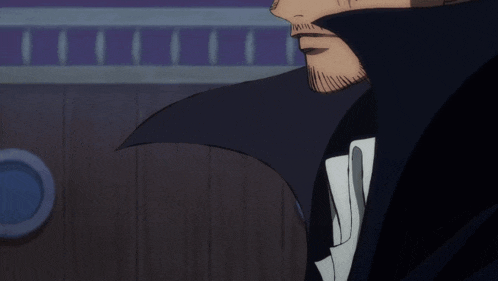 a man with a beard is wearing a black coat and white shirt