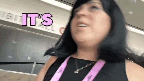 a woman wearing a lanyard that says it 's on it