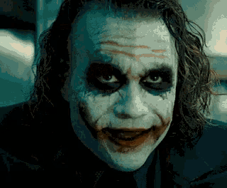 a close up of the joker 's face with his mouth open