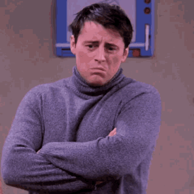 a man in a turtleneck sweater is saying he 's breathing .