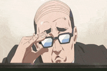 a bald man wearing glasses is looking at something