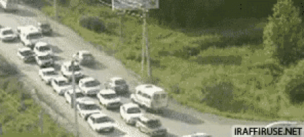 a bunch of cars are lined up on a road with the website iraffiruse.net in the bottom right corner
