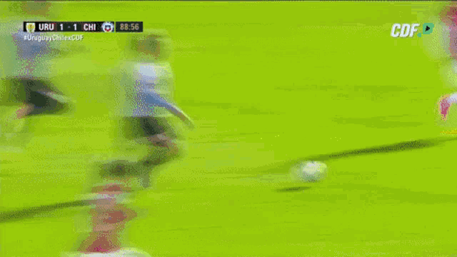 a soccer game between uruguay and chile is being shown on a television screen